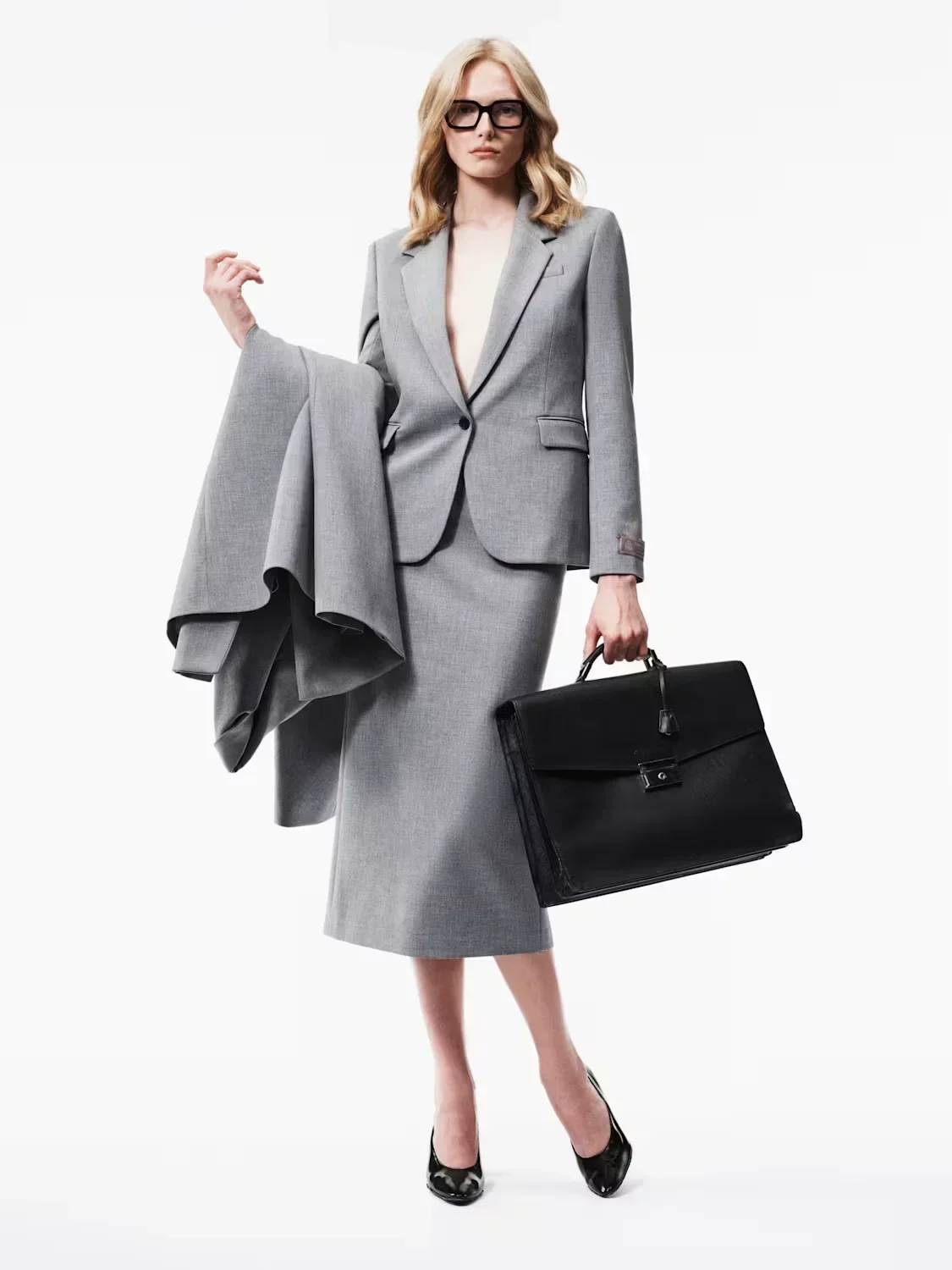 Alex Consani holding coat as The Legal Team in studio