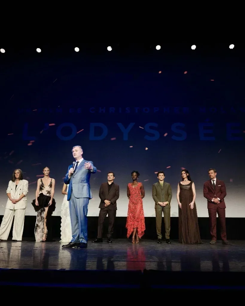 Director Christopher Nolan addressing the audience on stage with Anne Hathaway and the cast at Le Grand Rex