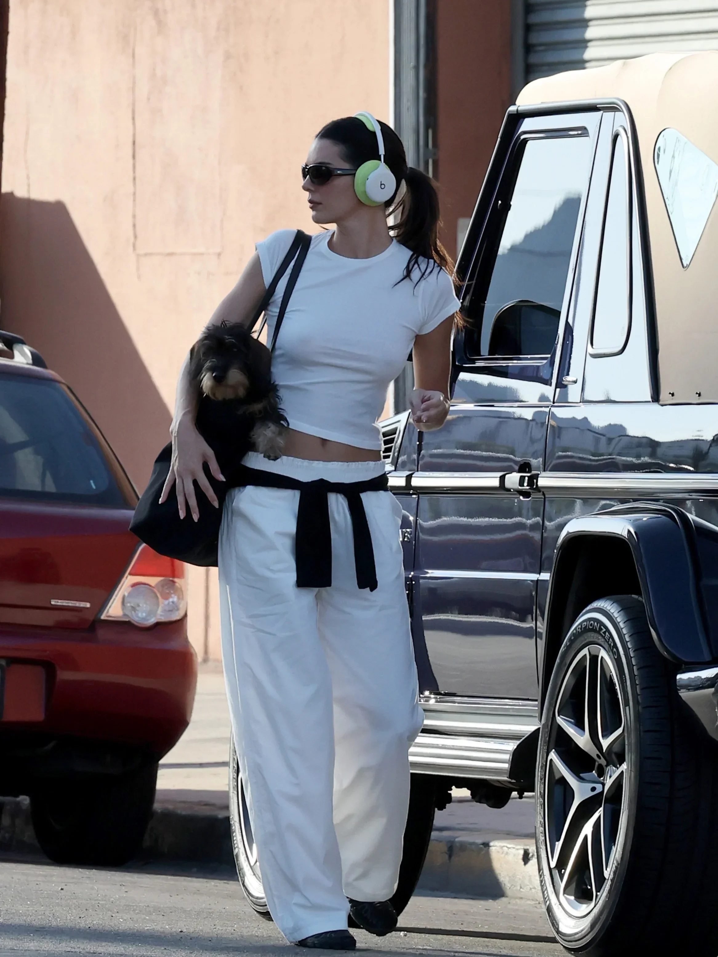 Kendall Jenner’s All-White Street Style Gets a Bold Twist With Lime-Green Headphones - Fashion look worn by Kendall Jenner