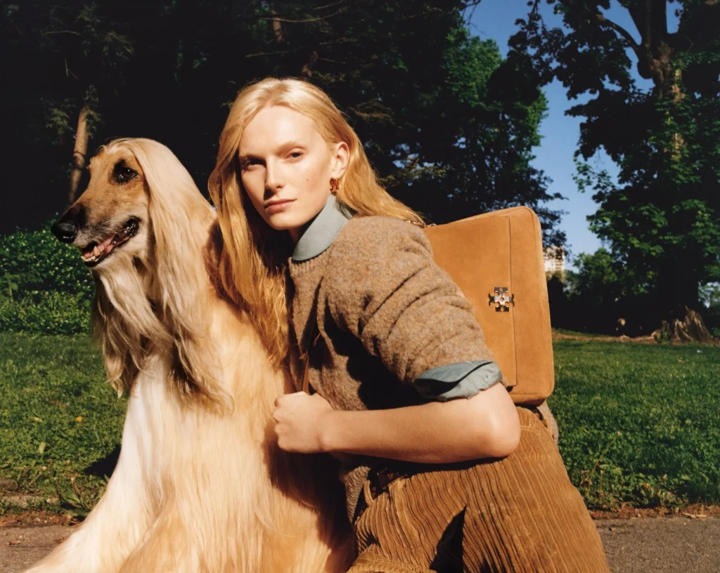 Alex Consani in Tory Burch wool sweater, corduroy pants, and Charlie shoulder bag