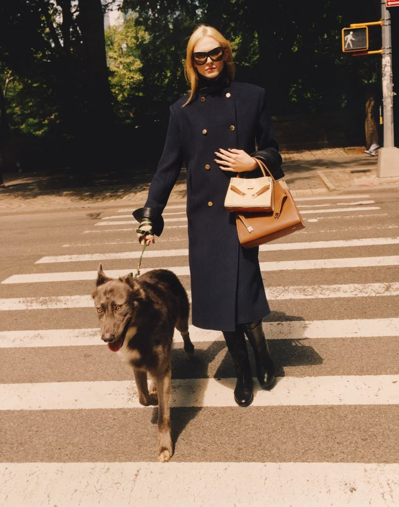 Alex Consani in Tory Burch navy double-breasted coat and runway wrap sunglasses