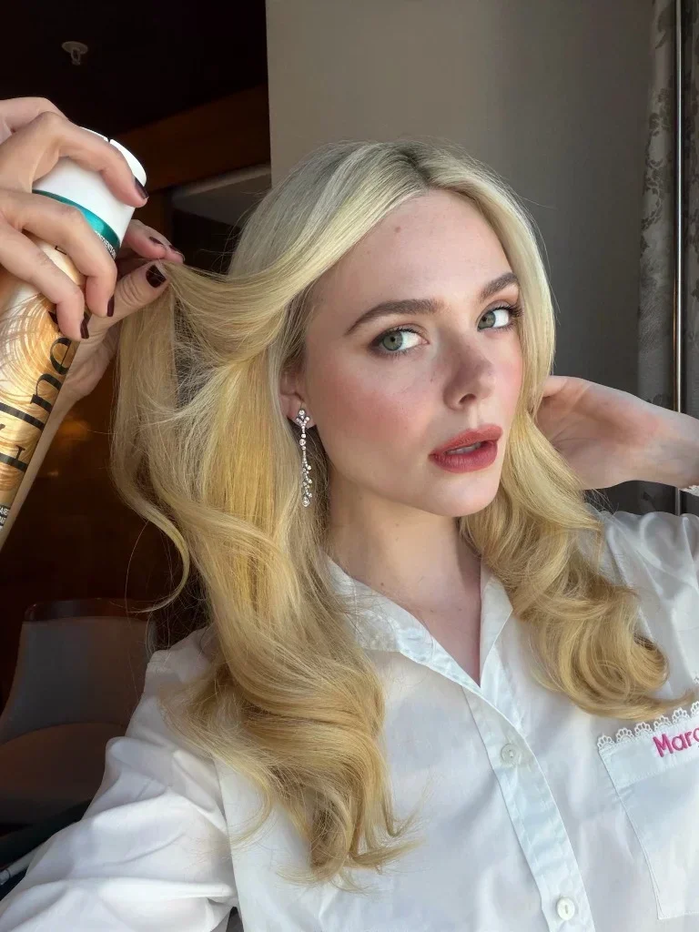Elle Fanning getting her flouncy barrel curls styled by Jenda Alcorn for the 2026 Emmys