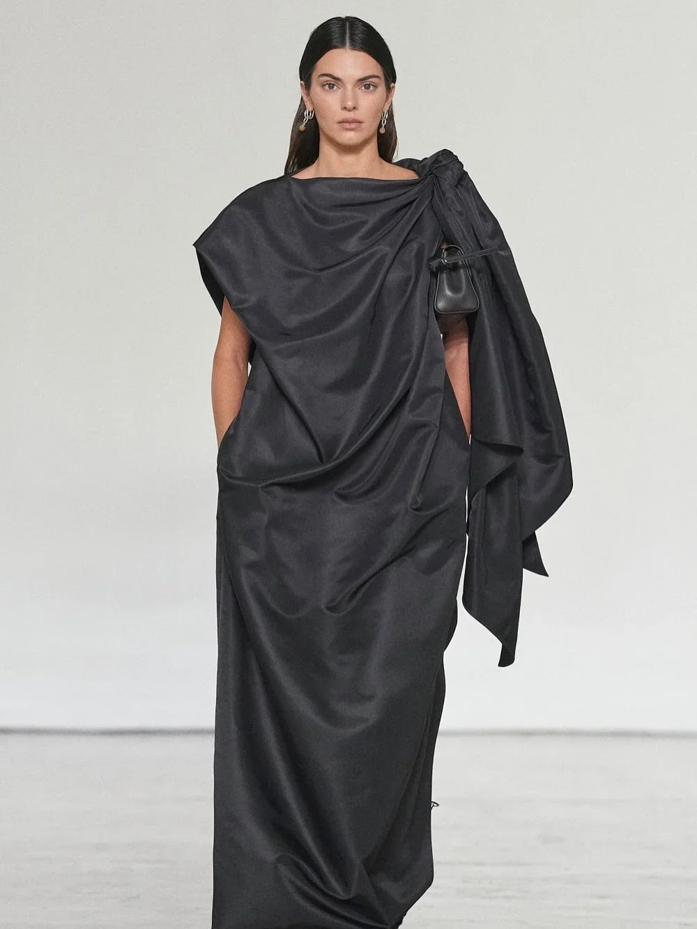 Kendall Jenner Closes Bottega Veneta Spring 2027 in a Sculptural Black Draped Gown - Fashion look worn by Kendall Jenner