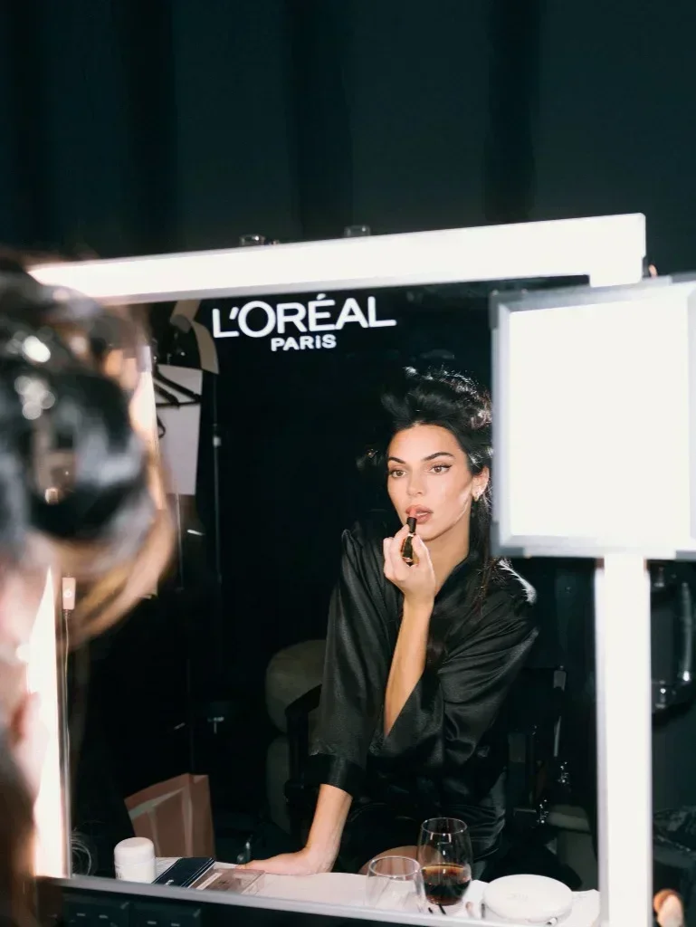 Kendall Jenner backstage preparing beauty look for L'Oréal Paris
