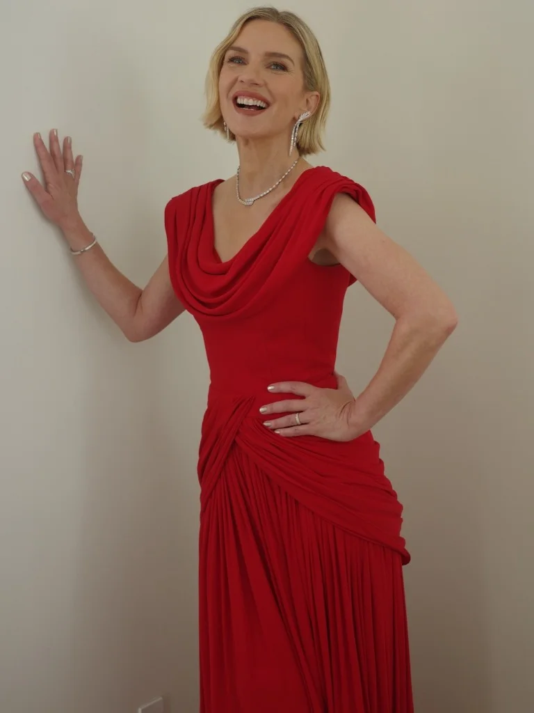 Rhea Seehorn in a custom draped red Louis Vuitton gown styled by Elizabeth Stewart