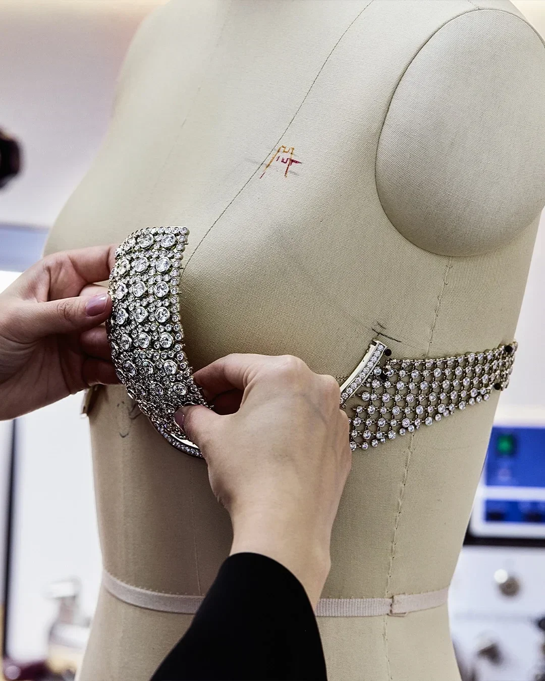 Jacob & Co. artisans fitting the diamond Fantasy Bra cup and framing bar onto a mannequin form