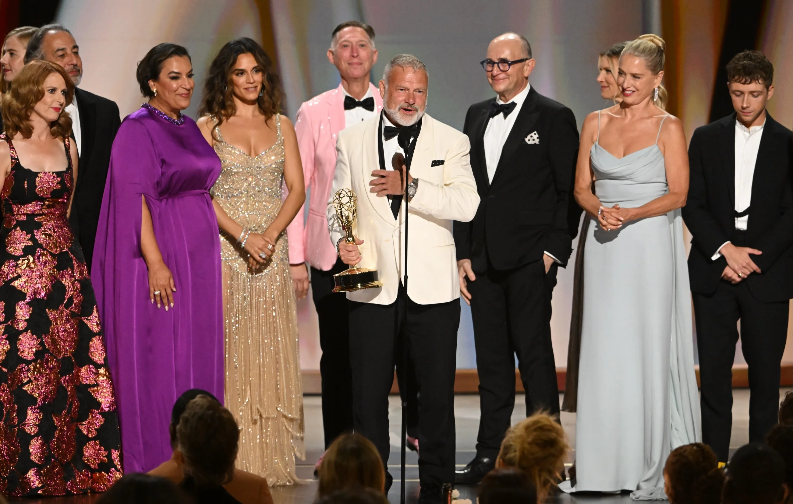 Rhea Seehorn in draped crimson gown beside Vince Gilligan