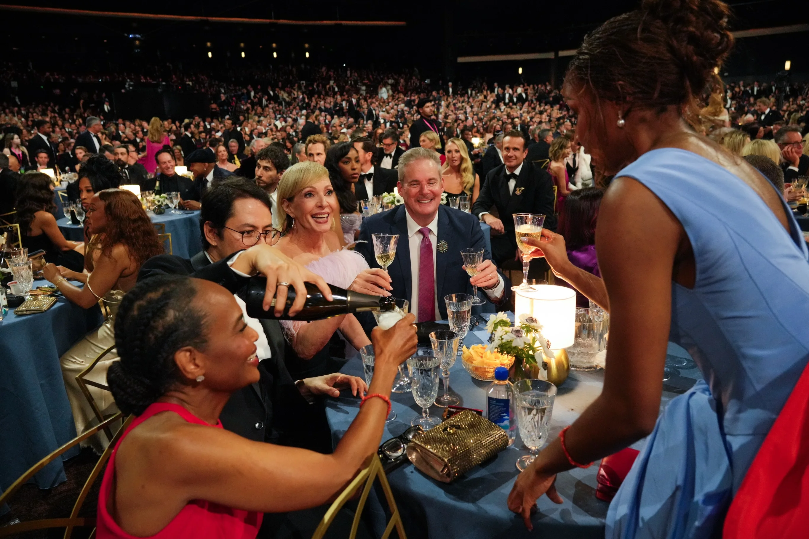 Oscar Isaac and Youn Yuh-jung raising champagne flutes together