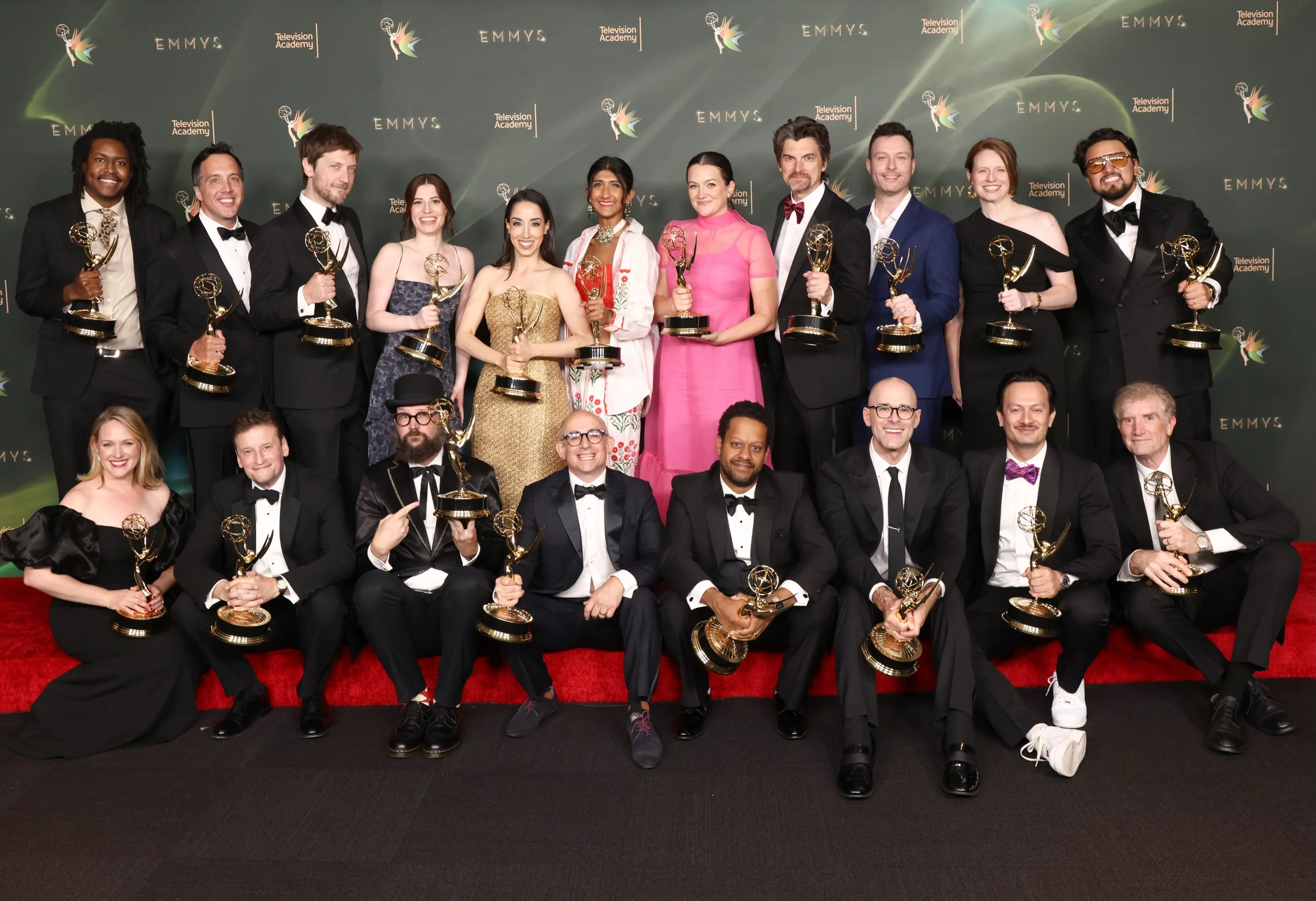 The Shogun ensemble and producers posing with multiple Emmys in the press room
