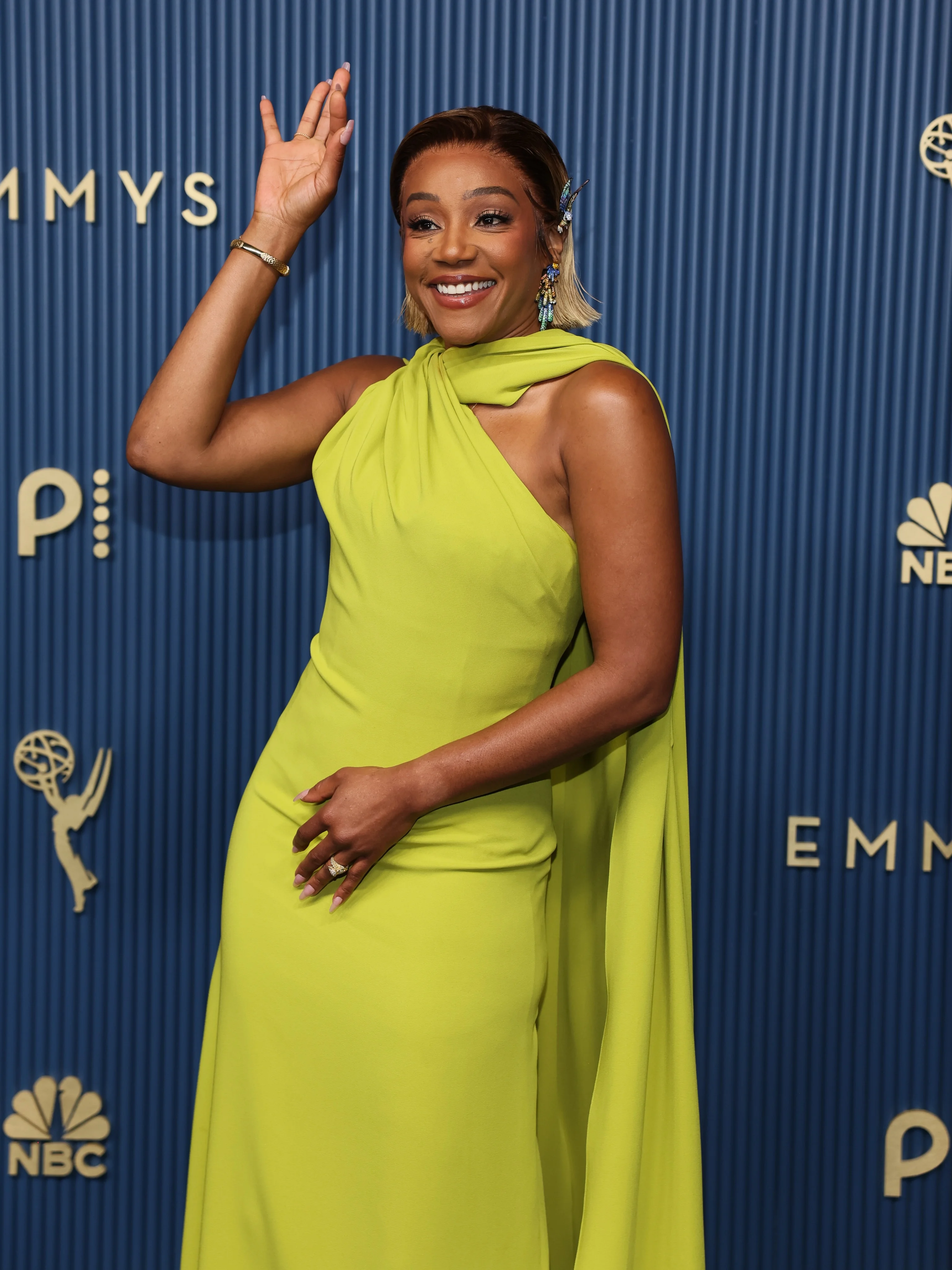 Tiffany Haddish in vibrant neon chartreuse one-shoulder gown