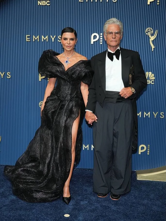 Ted Danson and Mary Steenburgen arriving arm-in-arm in classic black tie