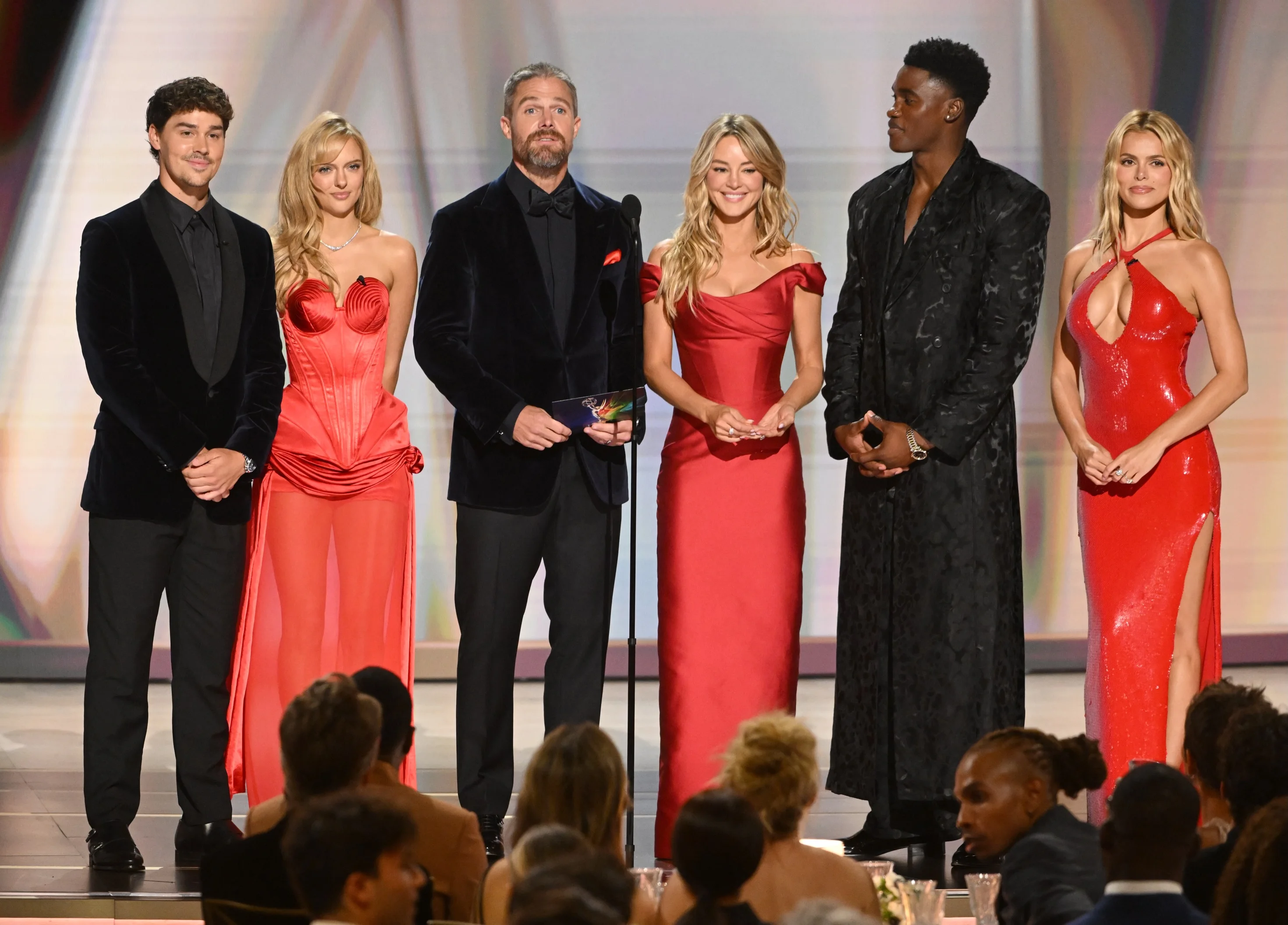 The entire comedy ensemble gathered on stage cheering in victory